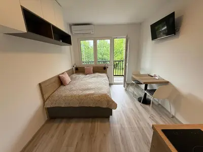 a bedroom with a bed and a desk and a table at Apartmán Slapy - Ždáň in Slapy