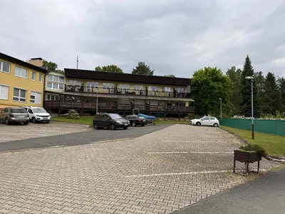a parking lot with cars parked in front of a building at Apartmán Slapy - Ždáň in Slapy