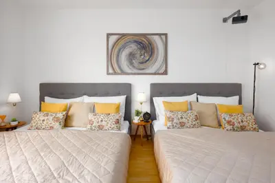 two beds sitting next to each other in a bedroom at Stylish Flat by the Metro in Prague