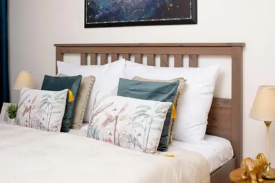 a bedroom with a bed with white pillows at Stylish Flat by the Metro in Prague
