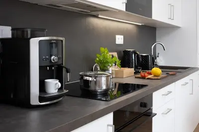 a kitchen with a coffee maker on a counter at Stylish Flat by the Metro in Prague