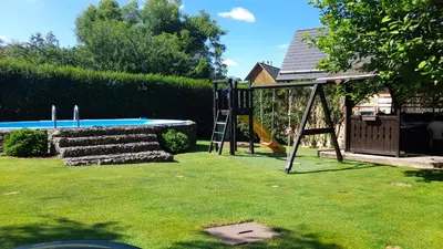 a playground with a slide and a swing set in a yard at Oáza klidu v Březové in Březová