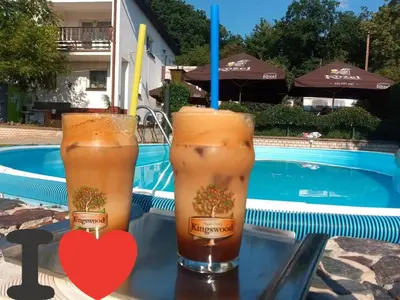 two drinks on a table next to a pool at Oáza klidu v Březové in Březová