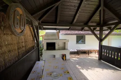 an outdoor patio with a stove and a table at Oáza klidu v Březové in Březová