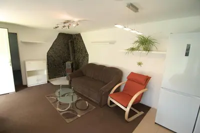 a living room with a couch and a chair at Oáza klidu v Březové in Březová