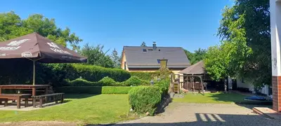a garden with a playground and an umbrella and a house at Oáza klidu v Březové in Březová