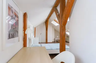 a room with a bed and a table in a room at Sokol House New Town in Prague