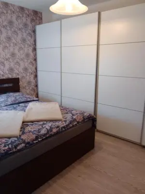 a bedroom with a bed with a large white closet at Apartmán Maria in Litoměřice