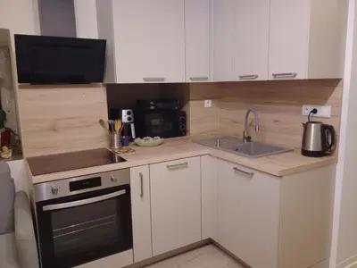 a kitchen with a sink and a stove top oven at Apartmán Maria in Litoměřice