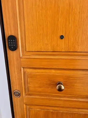 a wooden cabinet with a wooden door with a drawer at Cozy Luxe Home at the Heart of Old Prague Centre in Prague