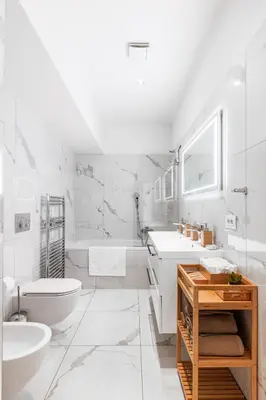 a white bathroom with a tub and a toilet and a sink at Cozy Luxe Home at the Heart of Old Prague Centre in Prague