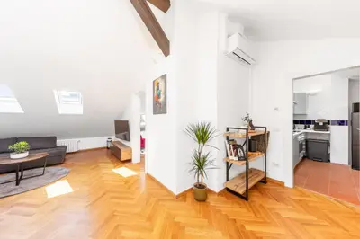 an open living room with a couch and a table at Cozy Luxe Home at the Heart of Old Prague Centre in Prague
