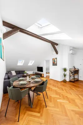 a living room with a table and chairs and a couch at Cozy Luxe Home at the Heart of Old Prague Centre in Prague