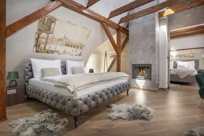 a large room with a bed and a tub at Kaiserstein Palace Apartments in Prague
