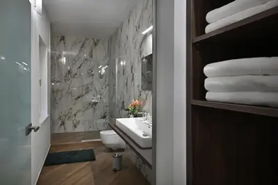 a bedroom with a large bed and a dining room at Kaiserstein Palace Apartments in Prague