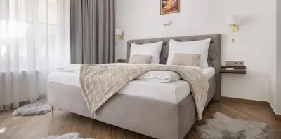a bedroom with two beds and a table in it at Kaiserstein Palace Apartments in Prague