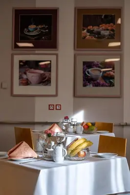 a table with a white table cloth with fruit on it at Hotel Junior Poděbrady in Poděbrady