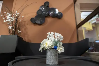 a vase with white flowers sitting on a table at Hotel Junior Poděbrady in Poděbrady