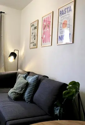 a living room with a couch and some pictures on the wall at Modern apartment in Zizkov 10 min from Wenceslav Square in Prague