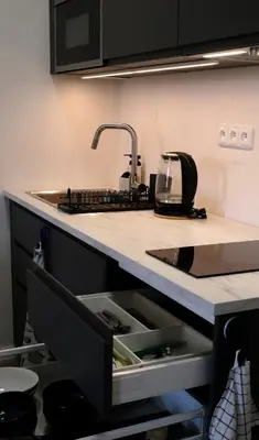 a kitchen counter with a sink and a sink at Modern apartment in Zizkov 10 min from Wenceslav Square in Prague