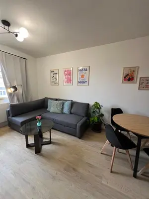 a living room with a couch and a table at Modern apartment in Zizkov 10 min from Wenceslav Square in Prague