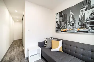 a living room with a couch and a picture on the wall at Boutique apartment Záhřebská in Prague