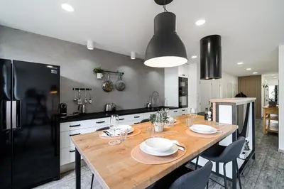 a kitchen with a wooden table with plates on it at Boutique apartment Záhřebská in Prague