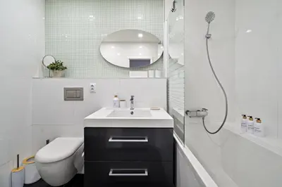 a bathroom with a sink and a toilet and a shower at Boutique apartment Záhřebská in Prague