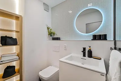 a bathroom with a white sink and a mirror at Boutique apartment Záhřebská in Prague