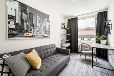 a living room with a couch and a desk at Boutique apartment Záhřebská in Prague