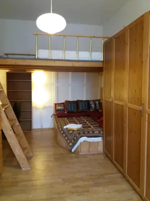 a room with a bunk bed and a staircase at Only Female Bedroom in a share flat in vinohrady in Prague