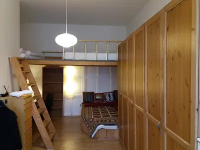 a room with a bunk bed and a ladder at Only Female Bedroom in a share flat in vinohrady in Prague