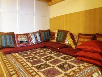 a couch with colorful pillows on it in a room at Only Female Bedroom in a share flat in vinohrady in Prague