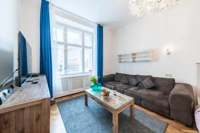 a living room with a couch and a table at Dušní Street Gem in Prague