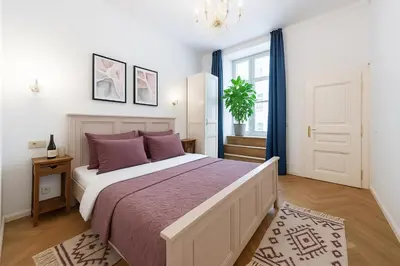 a bedroom with a large bed with purple pillows at Dušní Street Gem in Prague