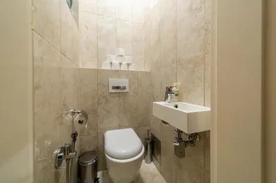 a bathroom with a toilet and a sink at Dušní Street Gem in Prague