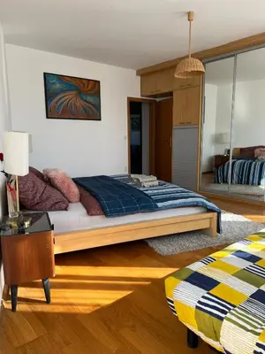 a bedroom with a large bed and a table at A large 1 bedroom apartment with an available private parking in Prague