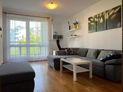 a living room with a couch and a table at A large 1 bedroom apartment with an available private parking in Prague