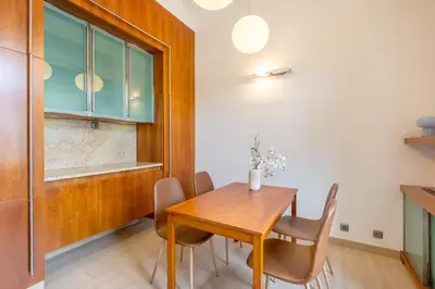 a dining room with a wooden table and chairs at Bright OldTown 2bdr apartment in Prague