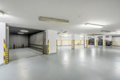 an empty parking garage with cars parked in it at Bright OldTown 2bdr apartment in Prague