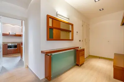 a kitchen with white walls and a wooden counter top at Bright OldTown 2bdr apartment in Prague
