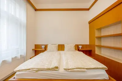 a bedroom with a large bed with a large window at Bright OldTown 2bdr apartment in Prague