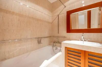 a bathroom with a tub and a sink and a mirror at Bright OldTown 2bdr apartment in Prague
