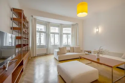 a living room with a white couch and a table at Bright OldTown 2bdr apartment in Prague