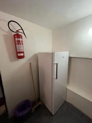 a fire hydrant hanging on a wall next to a refrigerator at Kolečko in Křivoklát