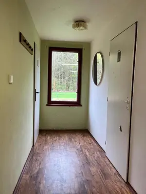 an empty room with a door and a window at Kolečko in Křivoklát
