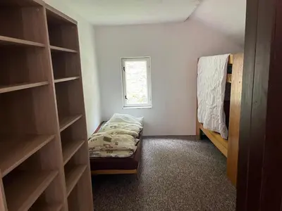 a small room with a bed and a window at Kolečko in Křivoklát