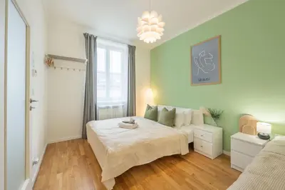 a bedroom with a bed and a couch at HOMELY I Central 38m2 APT I ELEVATOR I Self Check-In in Prague