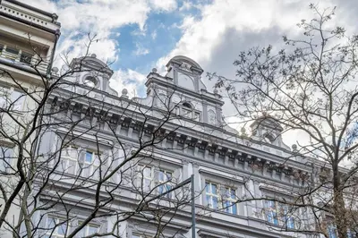 a white building with a clock tower on top of it at HOMELY I Central 38m2 APT I ELEVATOR I Self Check-In in Prague