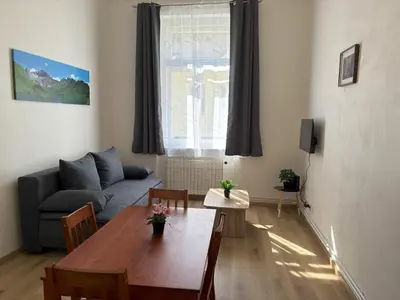 a living room with a table and a couch at Prague Deluxe City Center Apartment in Prague